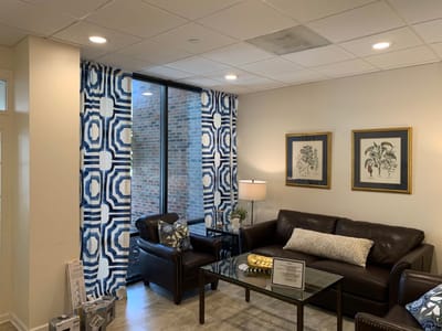Comfortable living room with stylish furnishings and colorful curtains