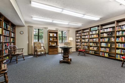 Library space with bookshelves and seating at Mt. Vernon Village.