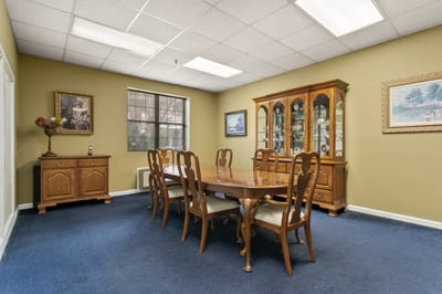Dining room with wooden table and chairs at Mt Vernon Village.
