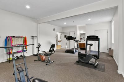 Gym with exercise equipment and weights at Mt Vernon Village.