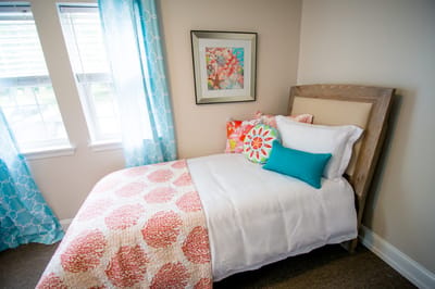 Cozy bedroom setup with colorful bedding and decor