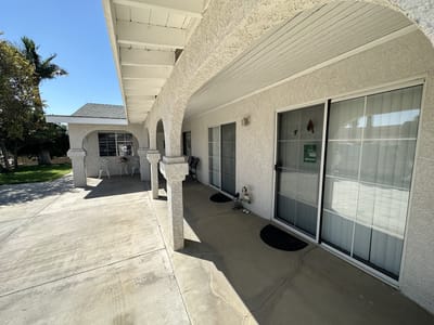 Exterior view of the facility showing patio seating area