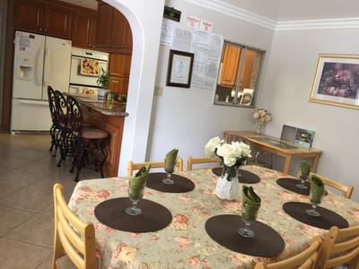 Bright dining area with flowers and table settings