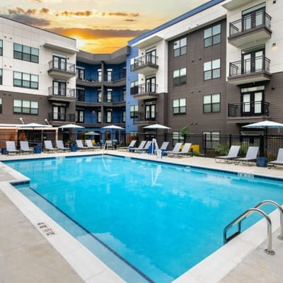 Outdoor pool area with lounge chairs and umbrellas