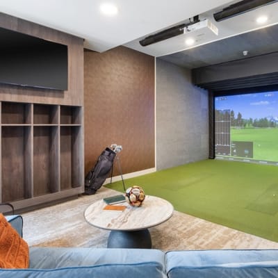 Interior gaming area with golf simulator and seating