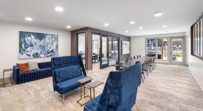 Bright common area with comfortable seating and large windows
