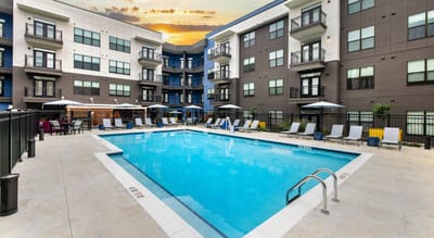 Outdoor pool area with seating and umbrellas