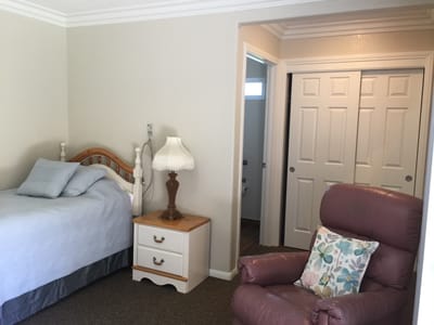 Cozy resident room with bed and chair