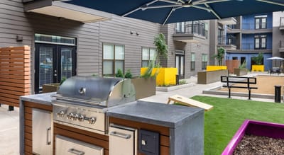 Outdoor barbecue area with grill and seating