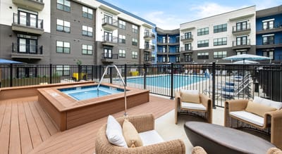 Outdoor pool area with seating and hot tub