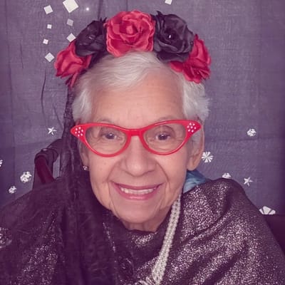 Elderly woman in festive attire and accessories