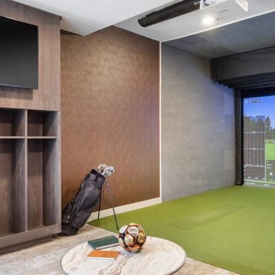 Interior of a fitness or recreational area with golf simulator
