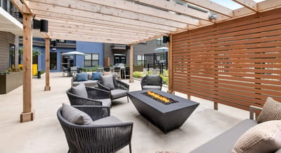 Outdoor seating area with a fire pit and comfortable chairs