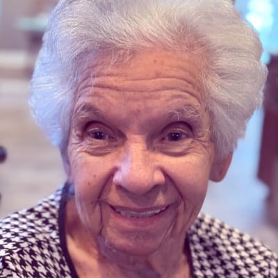 Smiling senior resident in a cozy indoor setting