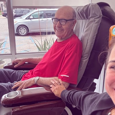 Senior resident smiling with staff member