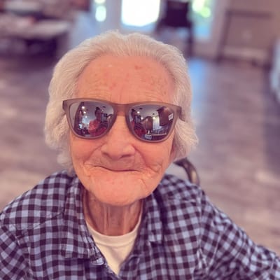 Senior woman smiling while wearing sunglasses