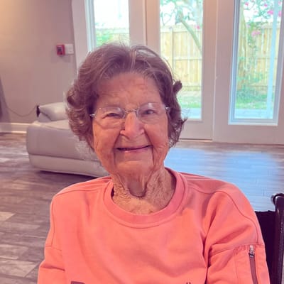 A smiling resident in a cozy interior setting