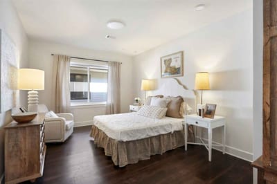 Cozy private resident room with a bed and seating area