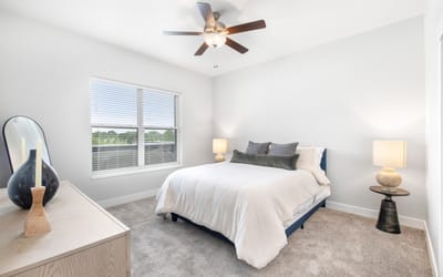 A modern bedroom with a bed and natural light