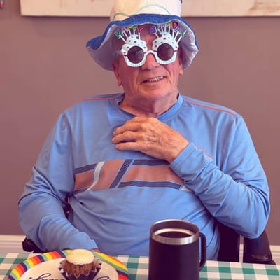 Resident celebrating with birthday hat and festive glasses