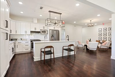Bright, modern common area with kitchen and seating