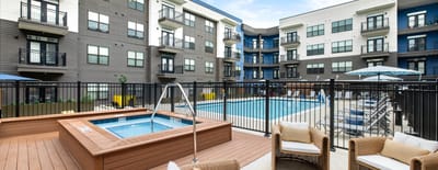 Outdoor pool area with lounge seating and umbrellas