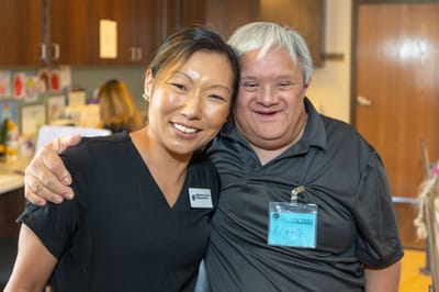 Staff member and resident sharing a joyful moment