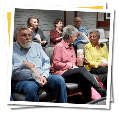 Residents enjoying snacks during a movie screening