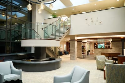 Bright interior common area with seating and staircase