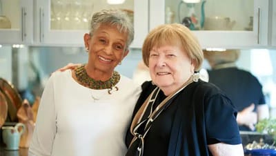 Two residents smiling together in a cozy setting
