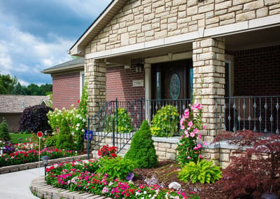 Exterior view of a senior care home entrance with landscaping