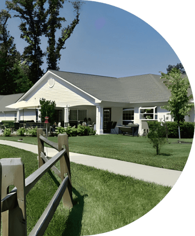 Exterior view of Olney Memory Care facility with gardens