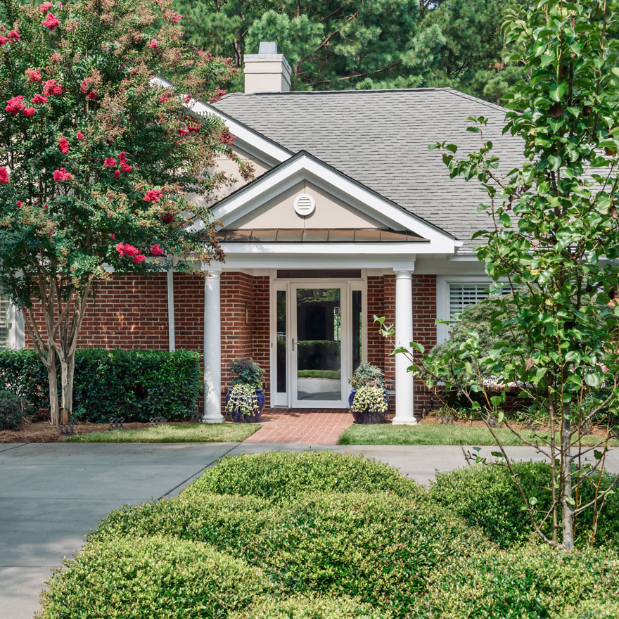 Exterior view of the facility's entrance surrounded by greenery