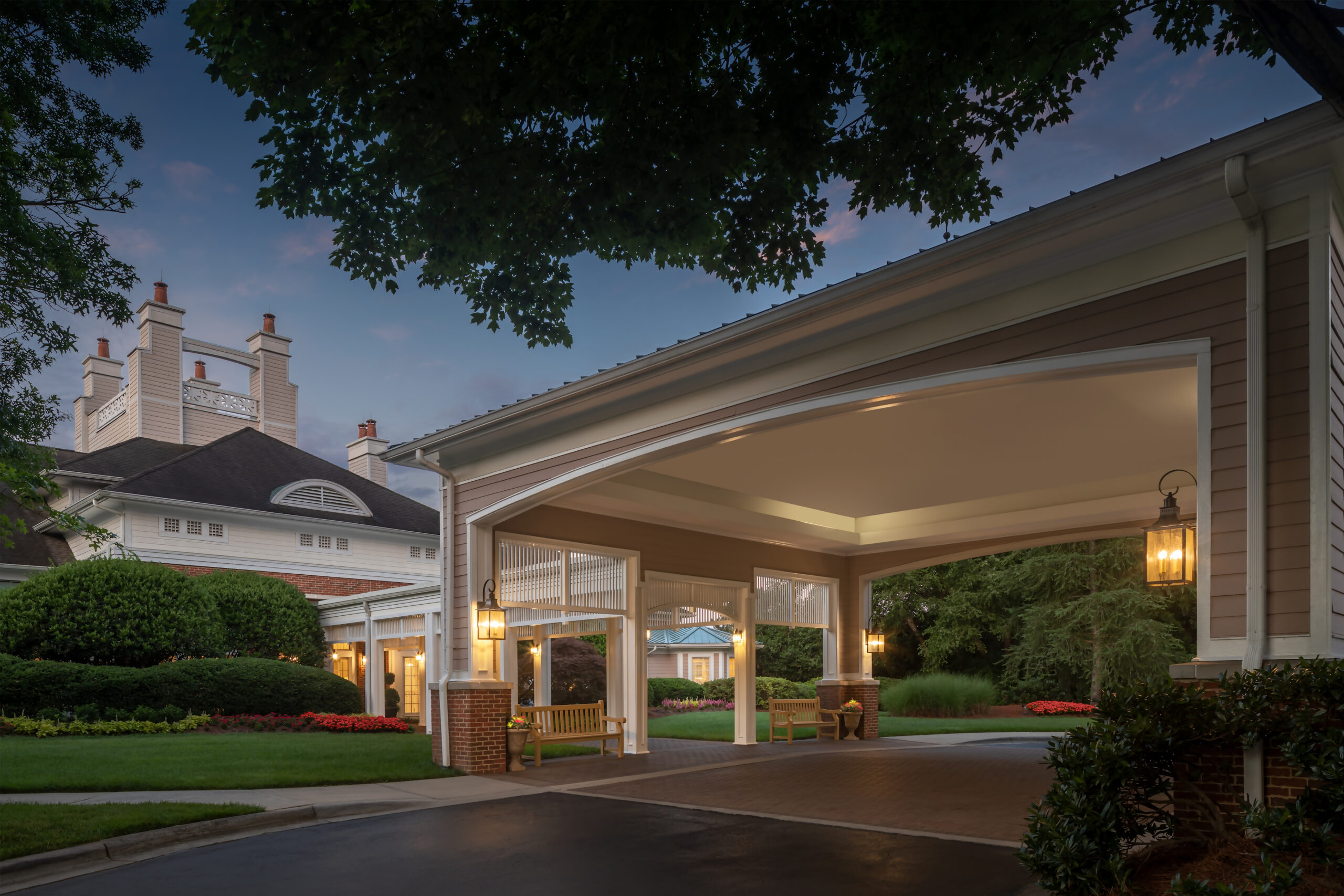 Exterior entrance of a senior living facility at dusk