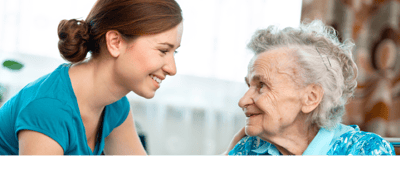 Caregiver interacting with elderly resident