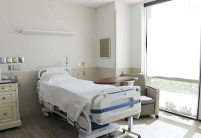 Patient room with a hospital bed and window