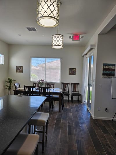 Bright common area with a dining table and seating