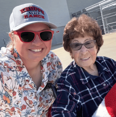Outdoor photo of a staff member with a resident.