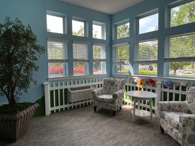 Sunlit common area with seating and decorations