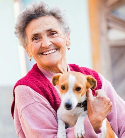 Acorn Manor Assisted Living, assisted living in The Woodlands, TX — Smiling elderly woman holding a small dog