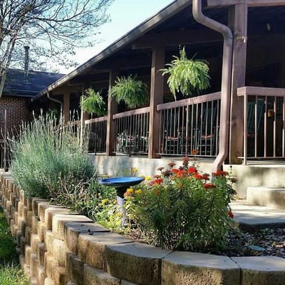 Beautifully landscaped outdoor area with flowers and hanging plants