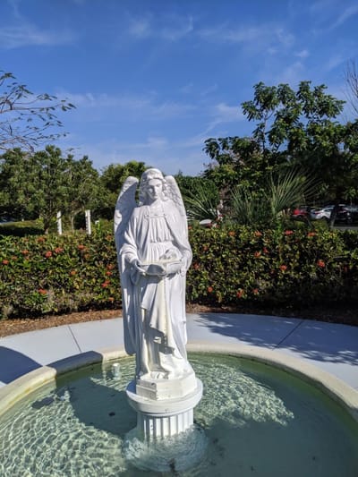 Statue of an angel in a garden setting