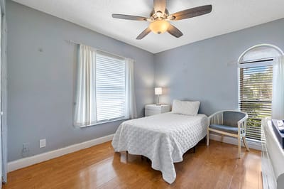 A private resident room with a bed and a window