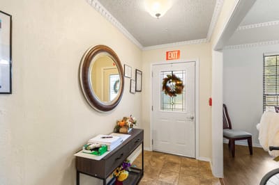 Bright interior hallway with a mirror and wreath