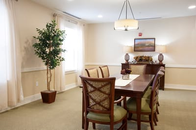 Interior dining room with a large table and plants