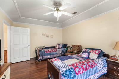 Cozy resident room with two beds and a ceiling fan