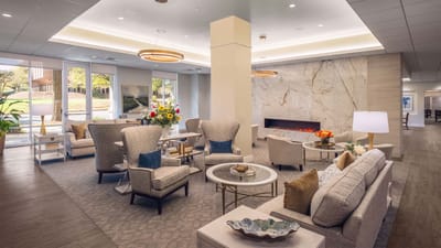Bright common area with comfortable seating and a fireplace