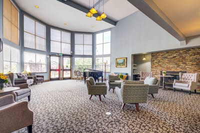 Bright common area with comfortable seating and piano