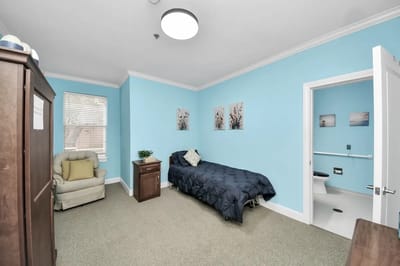 Cozy private resident room with blue walls and furniture