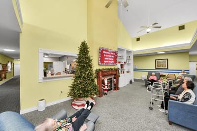 Residents enjoying time in a cozy common area decorated for the holidays